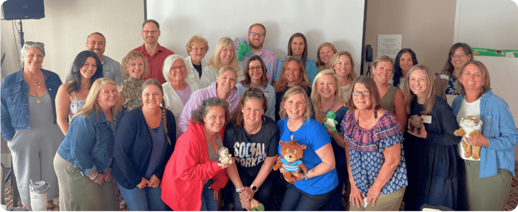 Group of educators smiling together at a Behavior Rewired Train-the-Trainer session after completing professional development on student behavior