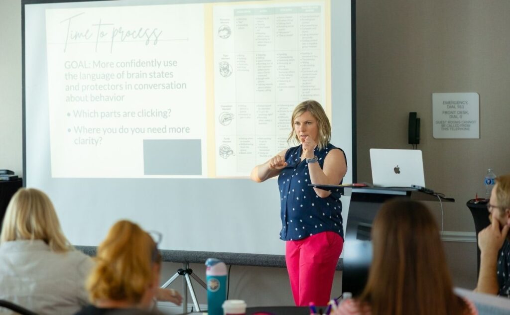 Jessica Sinarski conducts a session during the June Behavior Rewired Train-the-Trainer workshop in Texas, engaging participants in professional development.